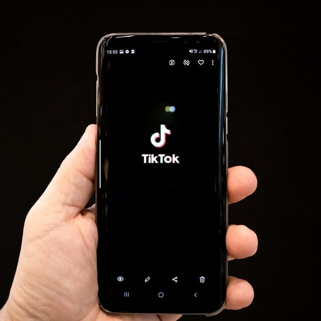 tiktok on phone help by a hand