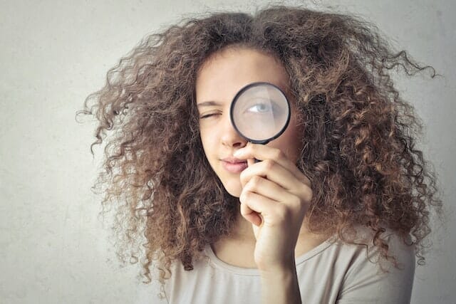 Woman holding a magnifying glass