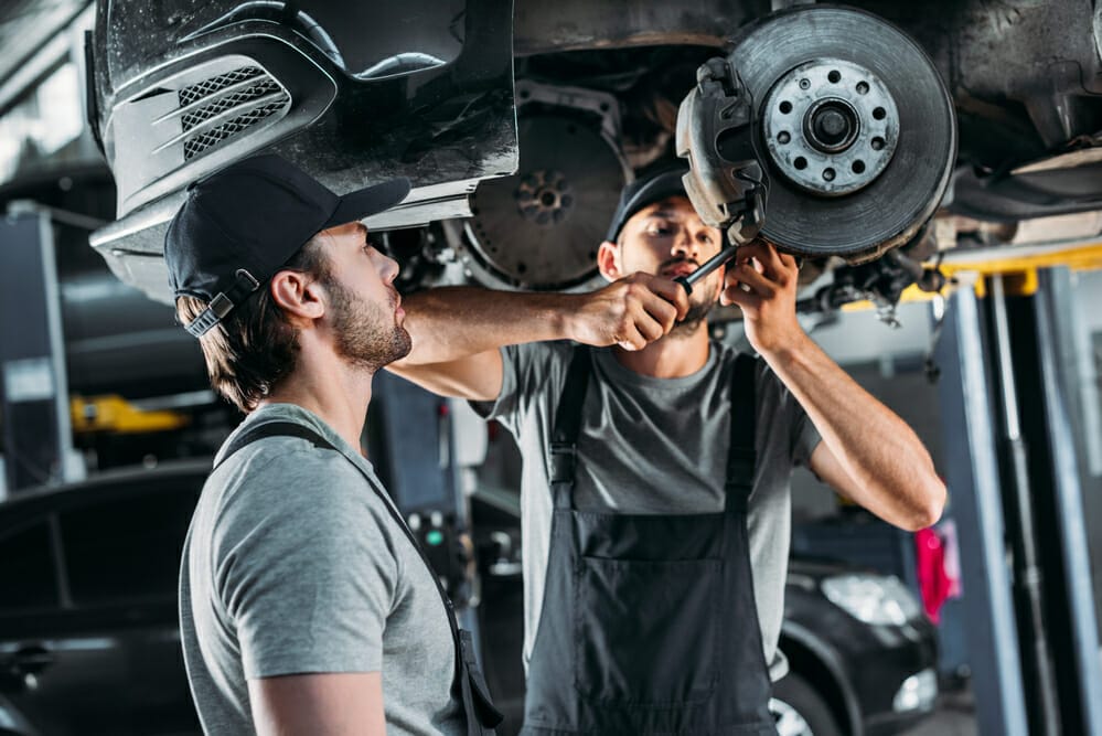 two men working in an auto repair shop