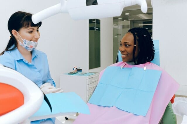 Image of a patient smiling at a dentist in a dental clinic