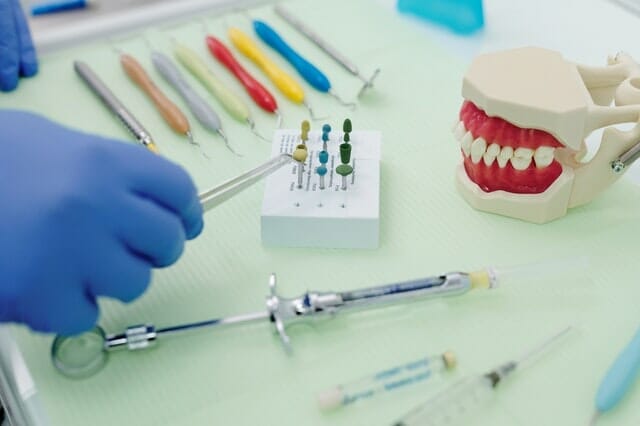 Dentist holding a tool in creating dentures