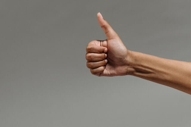 A man giving thumbs up because educational videos about a dental clinic makes treatments easier to understand 