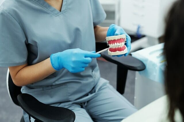 orthodontist showing a procedure to a client
