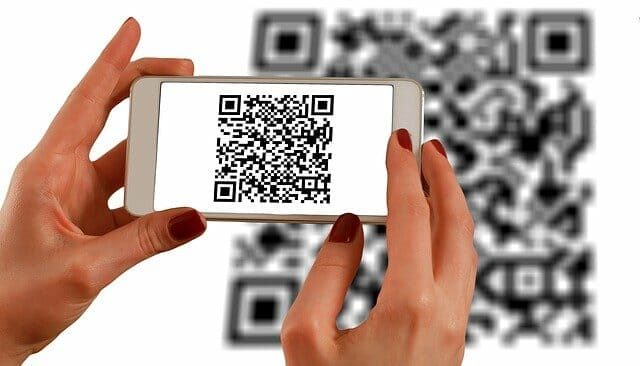 Phone scanning a QR code for dental practices