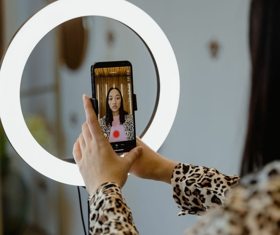 person with ringlight makingTikTok for orthodontists