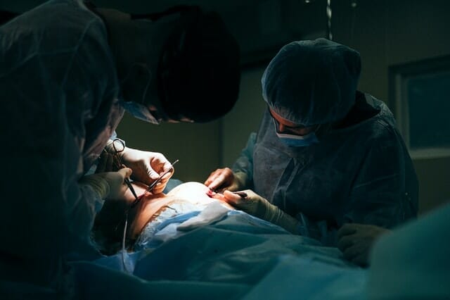On going surgery in an operating room with plastic surgeons