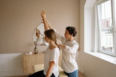 A chiropractor treating her patient's back pain