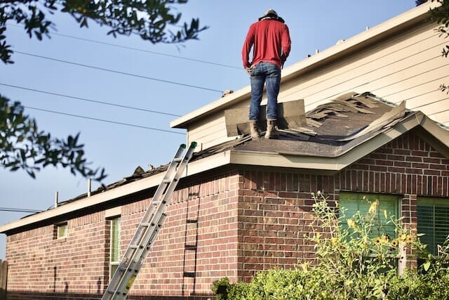 Roofer tearing down the roof 