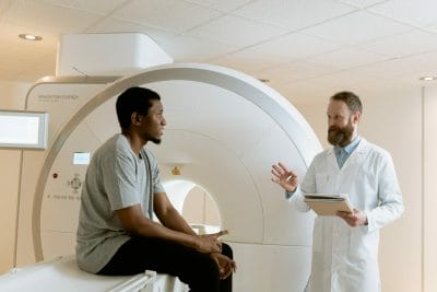 oncology doctor with patient and ct scan machine