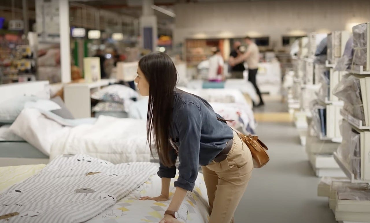 woman in mattress store shopping