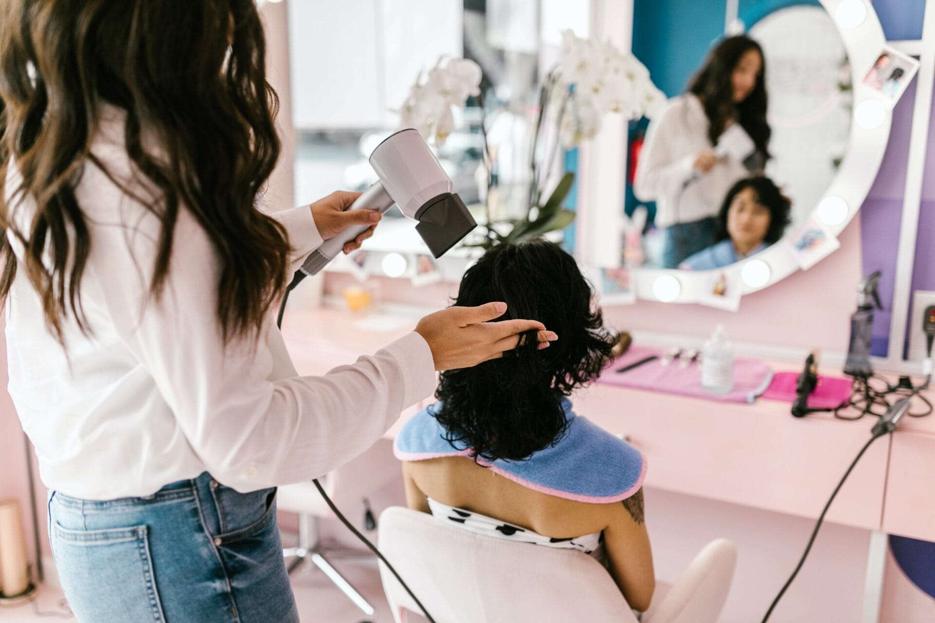 hair dresser treating customer hair at hair salon business