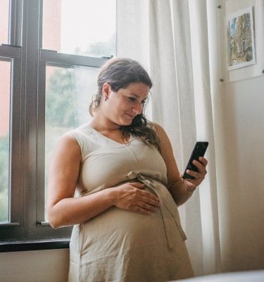 pregnant woman browsing for fertility clinics on tiktok