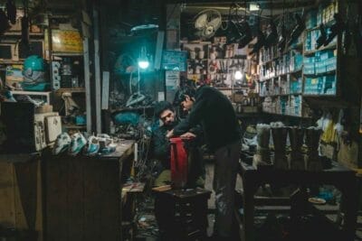 Two men repairing appliances in a workshop