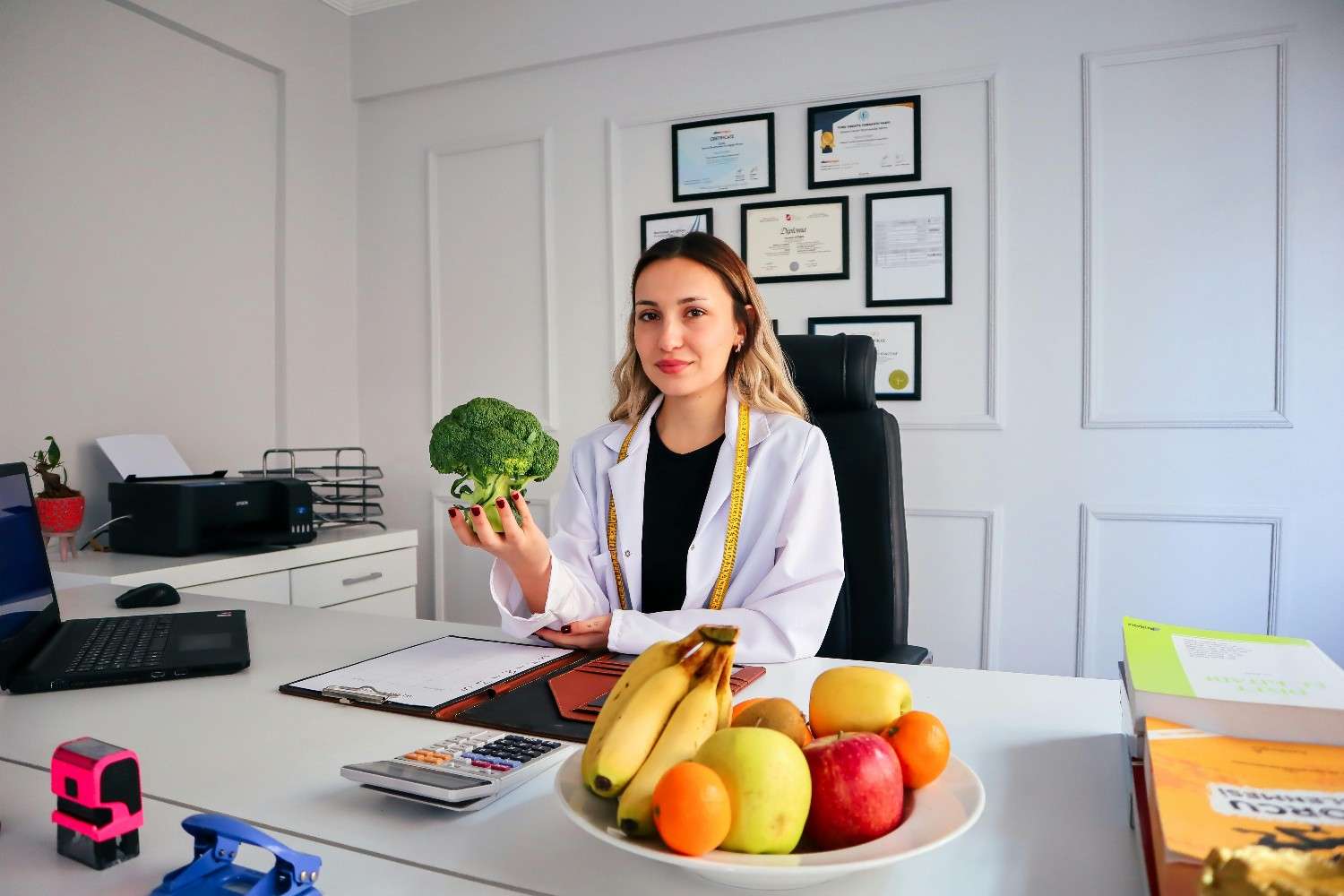Nutritionist Holding Broccoli in Office